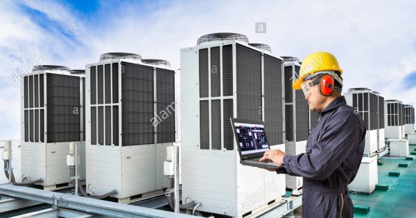 electrical-engineer-using-laptop-computer-for-maintenance-air-conditioning-K7TDRG